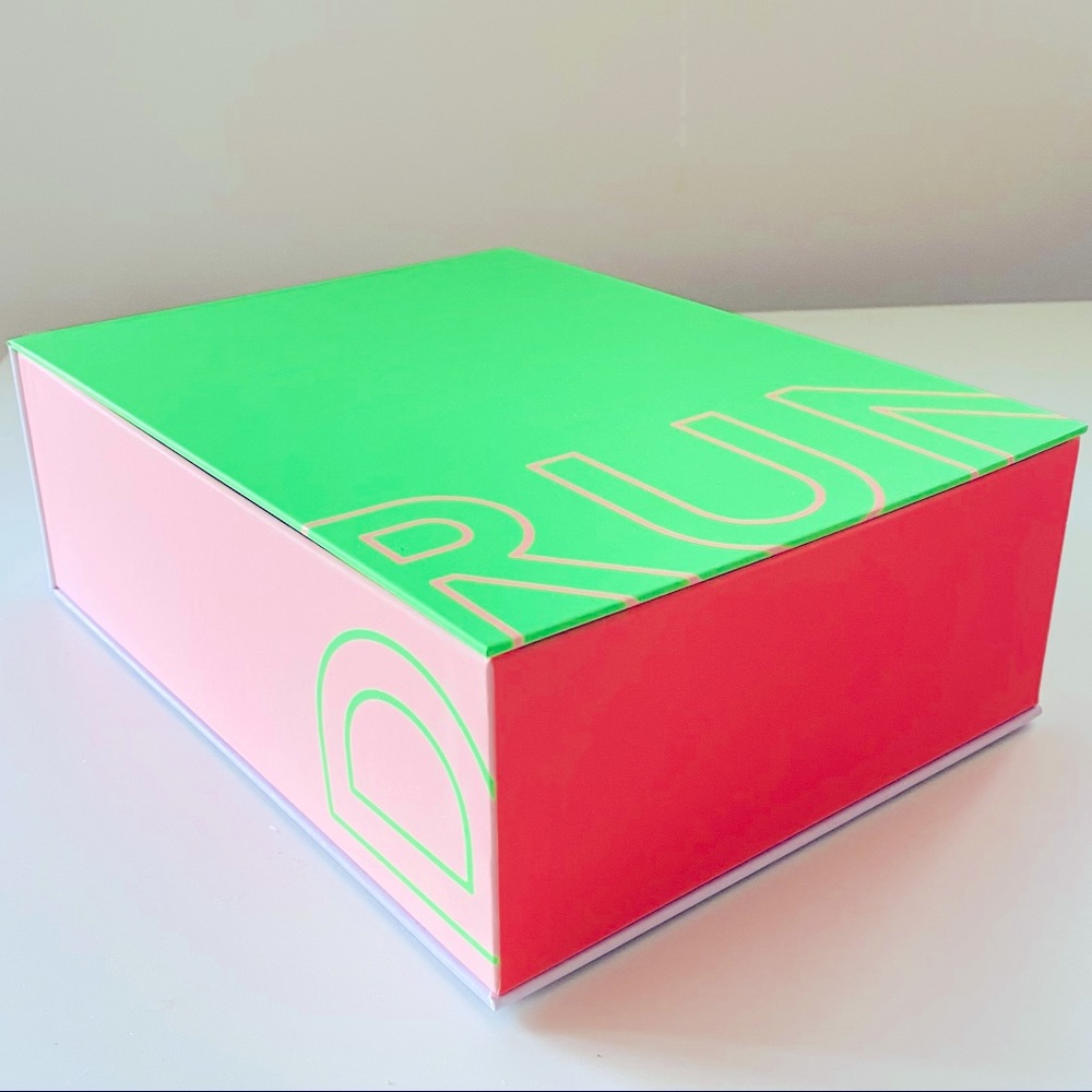 Drunk Elephant Neon coloured storage box with magnetic catch at edges